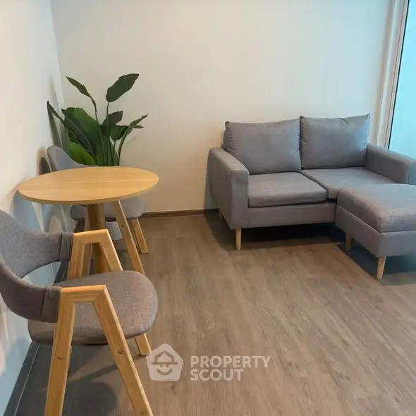 Modern living room with cozy gray sofa and wooden furniture