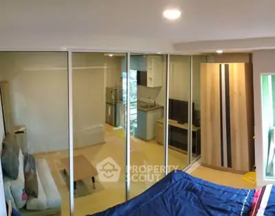 Modern studio apartment with glass partition and compact kitchen