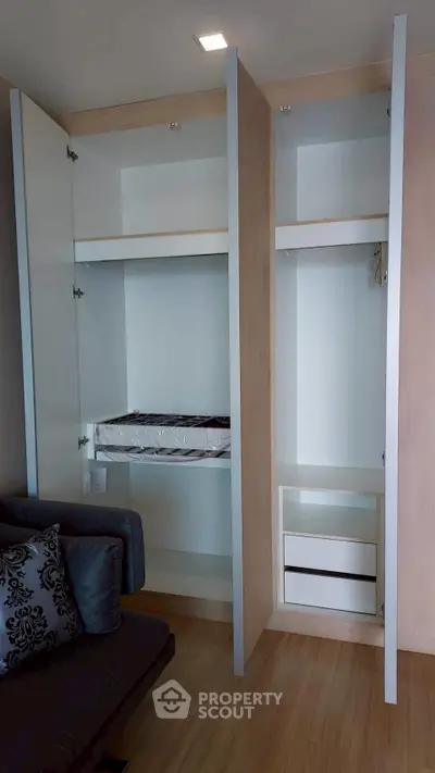 Modern apartment interior with built-in storage and stylish sofa, perfect for urban living.