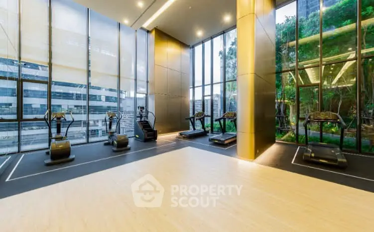 Luxurious gym with modern equipment and floor-to-ceiling windows offering stunning city views.