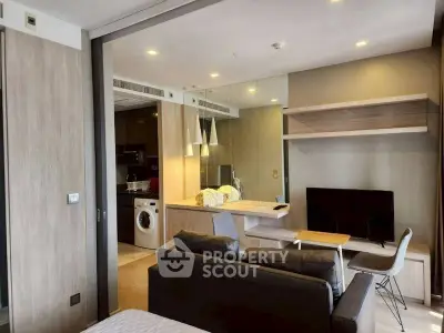 Modern living room with open kitchen and washing machine in stylish apartment