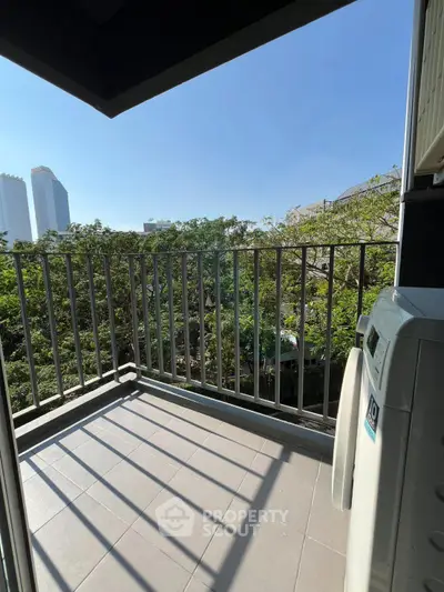 Charming balcony with city view and washing machine, perfect for urban living.