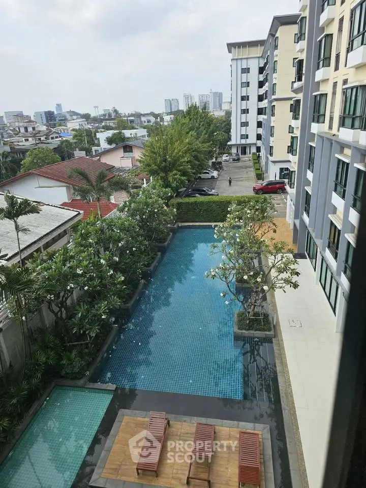 Stunning apartment view with pool and lush greenery, perfect for relaxation and urban living.