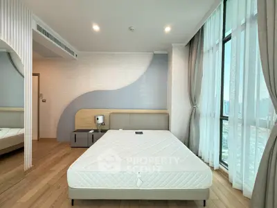 Modern bedroom with large windows and stylish decor in a high-rise apartment.