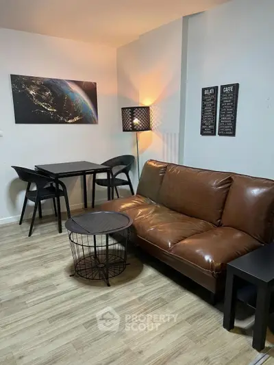 Cozy living room with leather sofa and modern decor, perfect for relaxation and entertaining.