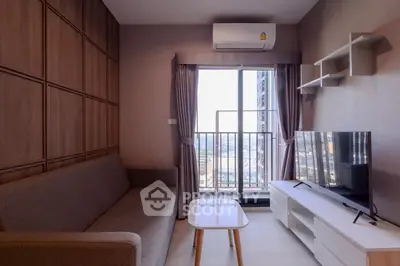 Modern living room with balcony view, sleek furniture, and natural light.