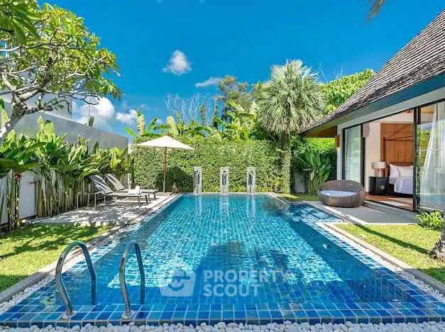 Luxurious villa with private pool and lush garden in tropical paradise setting.