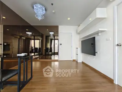 Spacious modern living room with elegant lighting and mirrored wall