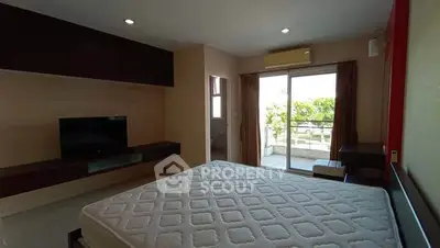 Spacious bedroom with balcony access and modern decor