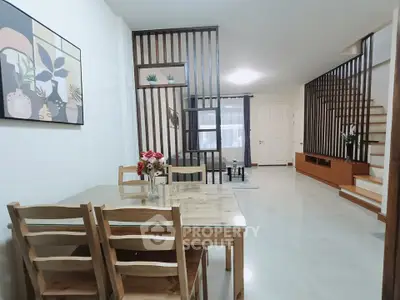 Spacious open-plan living and dining area with modern decor and wooden accents.