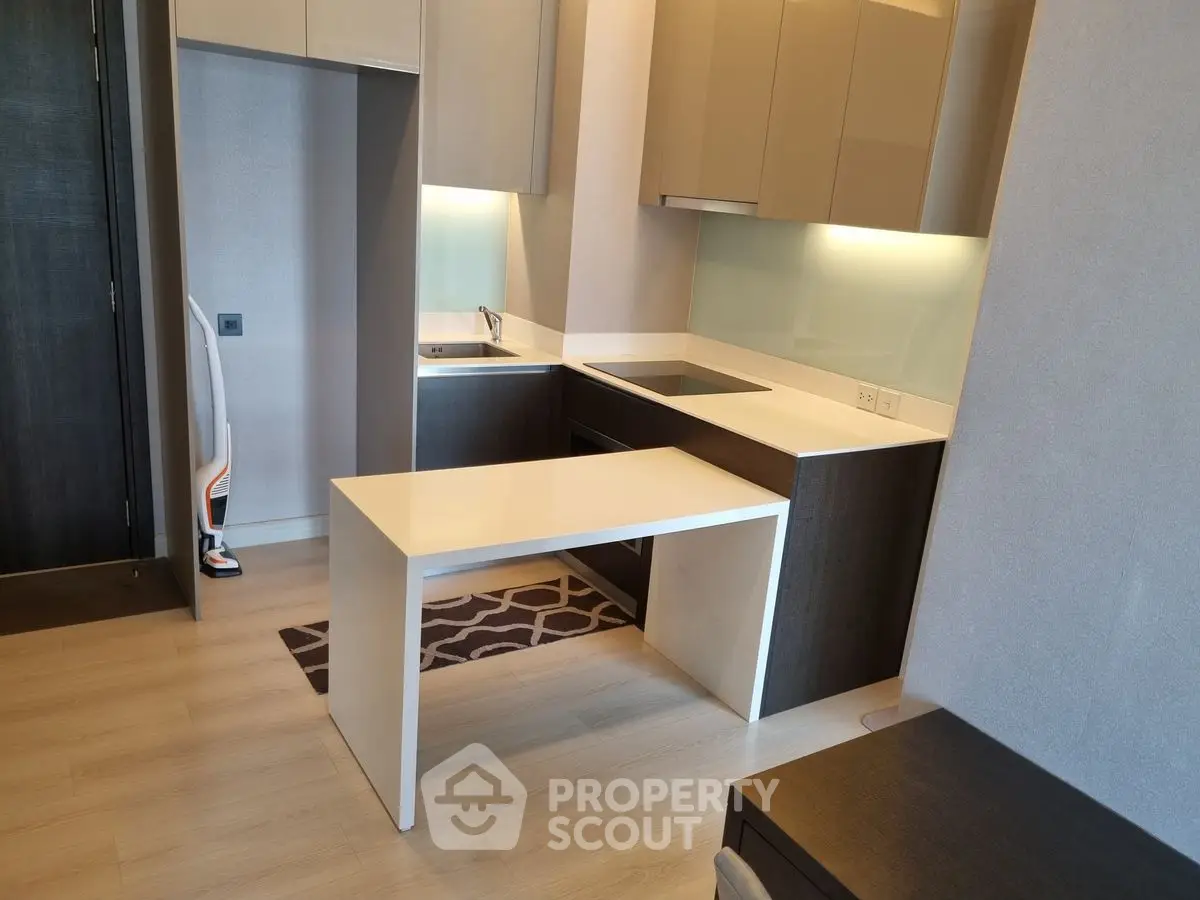 Modern kitchen with sleek cabinetry and integrated appliances in a compact layout.