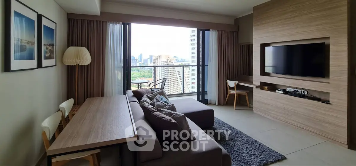 Modern living room with city view, stylish furniture, and large windows in a high-rise apartment.