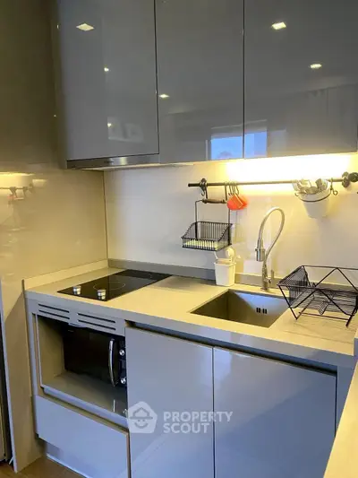 Modern kitchen with sleek cabinetry and built-in appliances, featuring a minimalist design.