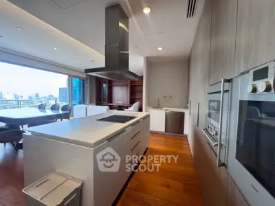 Luxurious modern kitchen with open layout and stunning city view, featuring sleek appliances and elegant dining area.