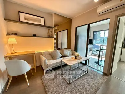 Modern living room with cozy seating and stylish decor in a contemporary apartment.