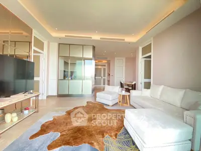 Luxurious living room with modern decor and plush seating, featuring a stylish cowhide rug and elegant lighting.