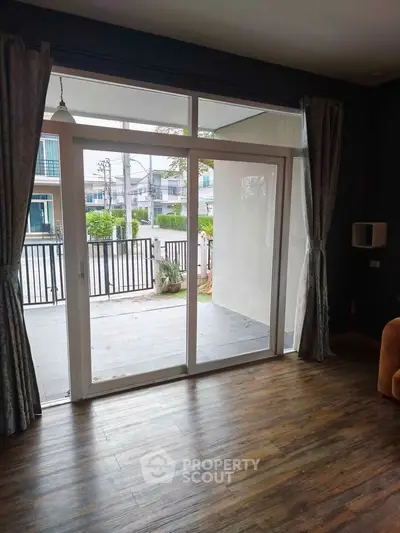 Spacious living room with large sliding glass doors opening to a private balcony.