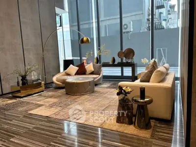 Luxurious modern living room with stylish furniture and floor-to-ceiling windows in urban setting.