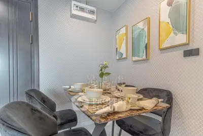 Elegant dining area with modern decor and stylish table setting in a contemporary apartment.