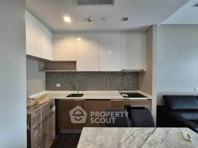 Modern kitchen with sleek cabinets and marble countertop in stylish apartment