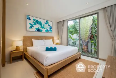 Luxurious bedroom with modern decor and garden view in a serene setting.