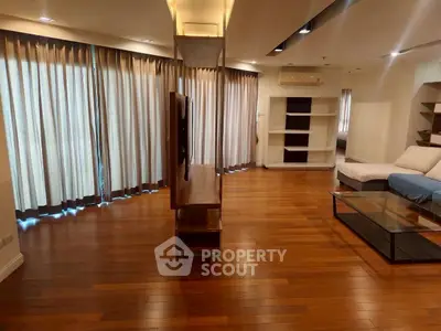 Spacious living room with wooden floors and modern furnishings