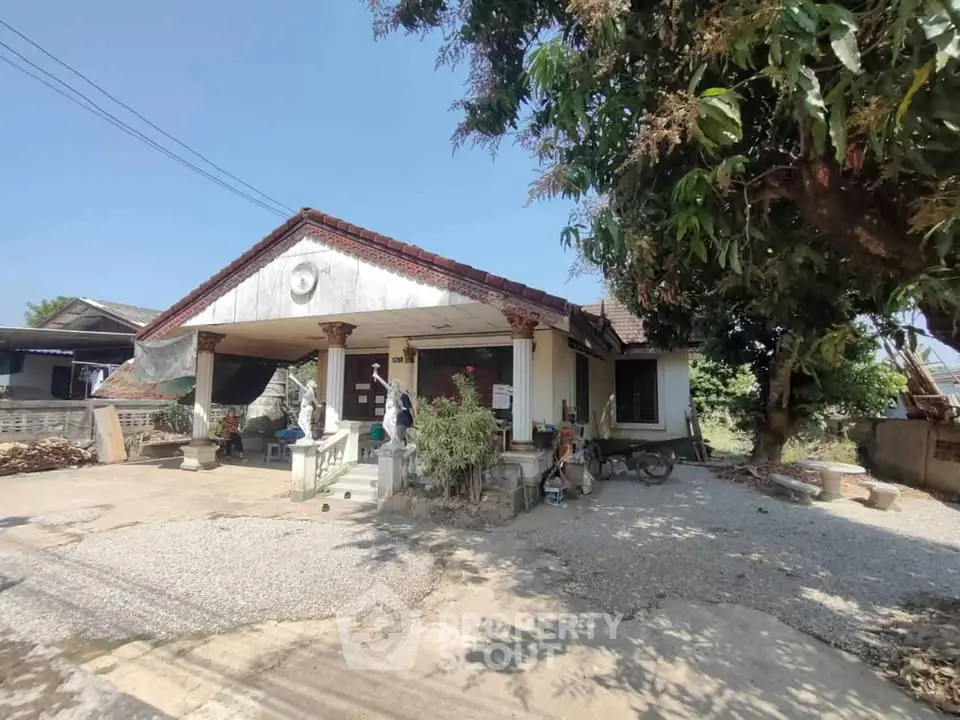 Charming rustic house with spacious yard and lush greenery, perfect for serene living.