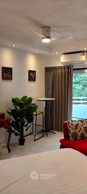 Cozy bedroom with modern decor and lush greenery view