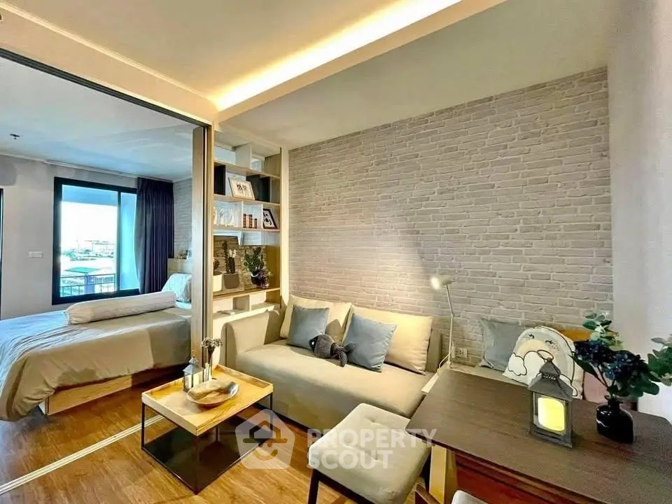 Modern living room with cozy seating and stylish decor adjacent to a bedroom with a view.