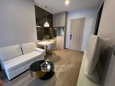 Modern living room with sleek furniture and elegant lighting in a stylish apartment.