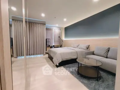 Modern bedroom with cozy seating area and stylish decor
