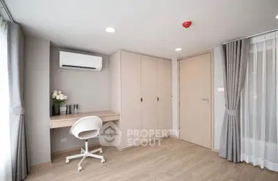 Modern study room with built-in desk, chair, and air conditioning in a bright apartment.