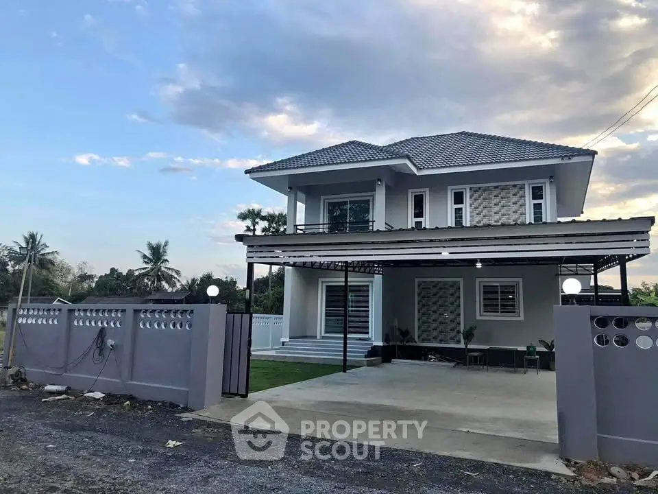 Modern two-story house with spacious driveway and landscaped garden