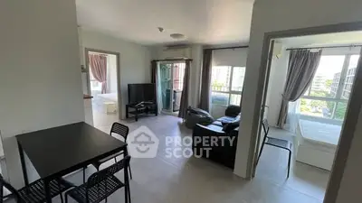 Spacious modern apartment with open living area and large windows offering abundant natural light.