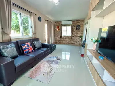 Spacious living room with modern decor and large windows for natural light.