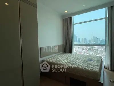 Modern bedroom with city view in high-rise apartment