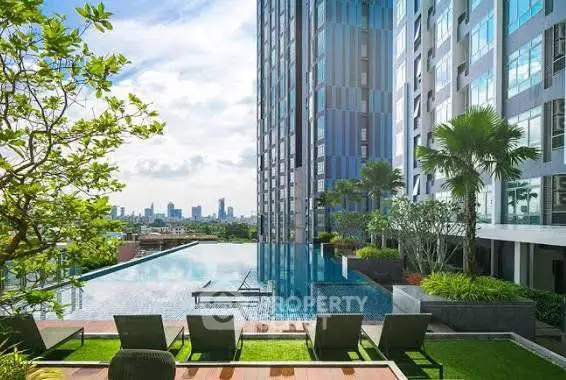 Luxurious rooftop pool with stunning city skyline view in modern high-rise building.