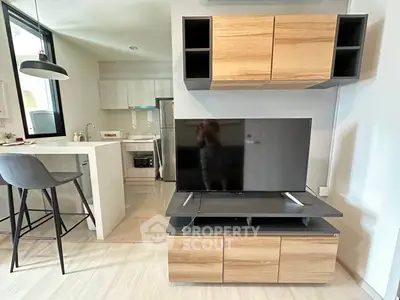 Modern living room with stylish wooden cabinets and sleek TV setup