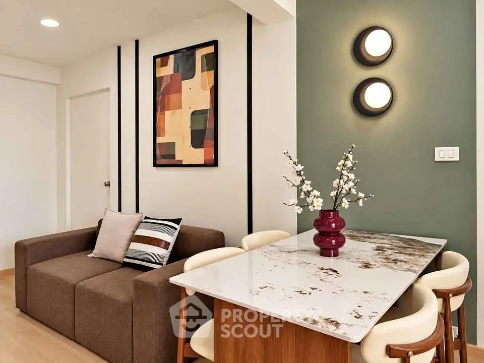 Modern living room with stylish decor and dining area featuring a marble table and contemporary lighting.