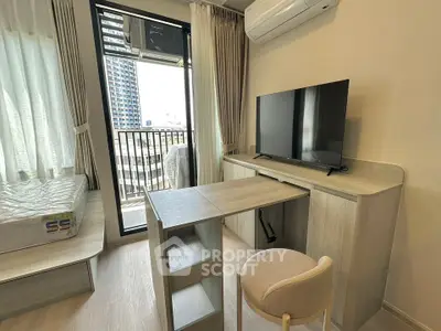Modern studio apartment with balcony and sleek furniture in urban setting