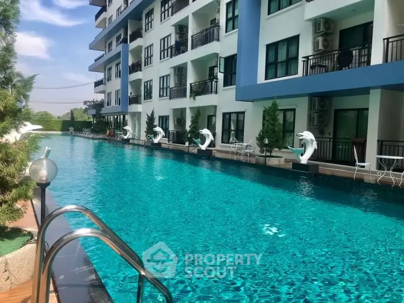 Luxurious apartment complex with stunning outdoor pool and modern balconies.