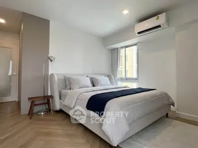 Modern bedroom with stylish decor and natural light in a contemporary apartment.
