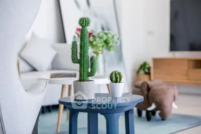 Stylish modern living room with cactus decor and elegant furnishings