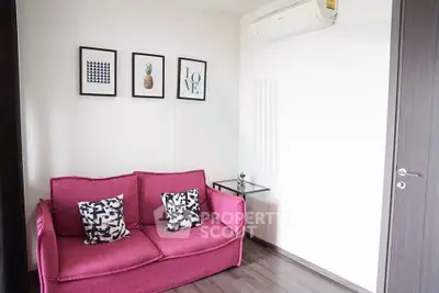 Chic modern living room with vibrant pink sofa and stylish wall art