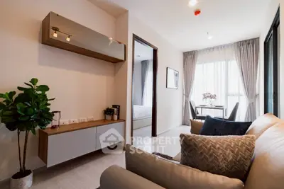 Modern living room with elegant decor and natural light, featuring a cozy sofa and stylish furniture.