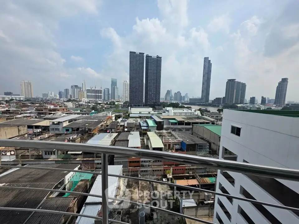 Stunning cityscape view from a high-rise balcony showcasing urban skyline and modern architecture.