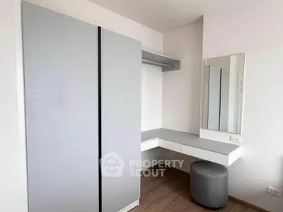 Modern minimalist bedroom with sleek wardrobe and vanity area