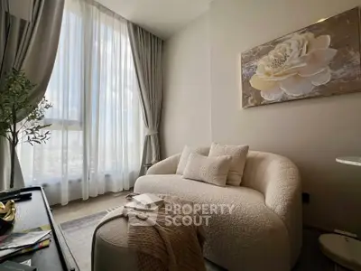 Elegant living room with plush sofa and large window offering city views