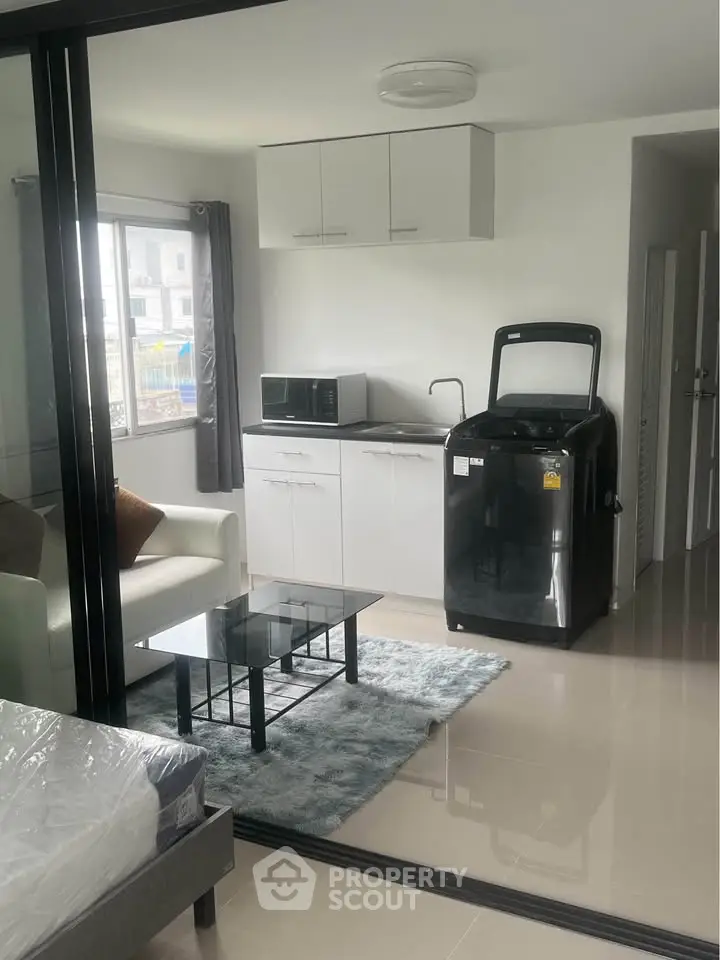 Modern studio apartment with sleek kitchen and cozy living area