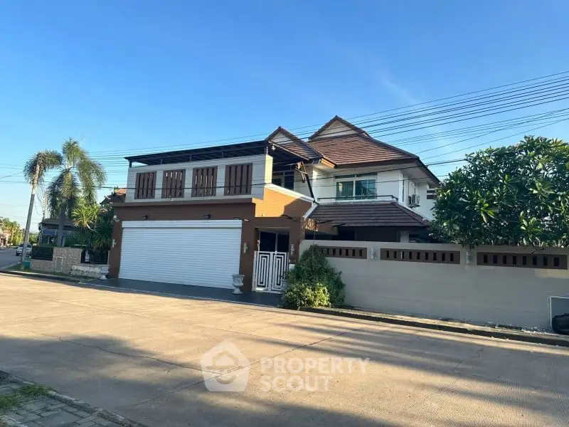 Charming two-story house with modern design and spacious driveway in a serene neighborhood.